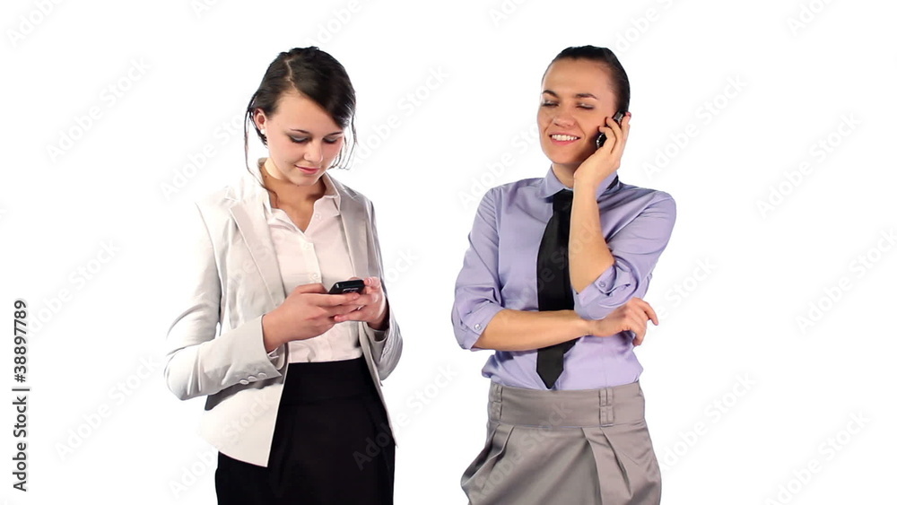 Young businesswomen using cellphones, isolated on white Young businesswomen using cellphones, isolated on white