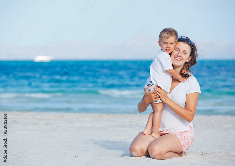 Young mother and her son playing at beach Young mother and her son playing at beach