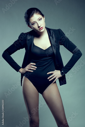 woman posing at studio, wearing black jacket