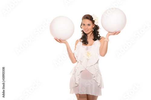 pregnant woman holding two white ball © Andrey Zametalov