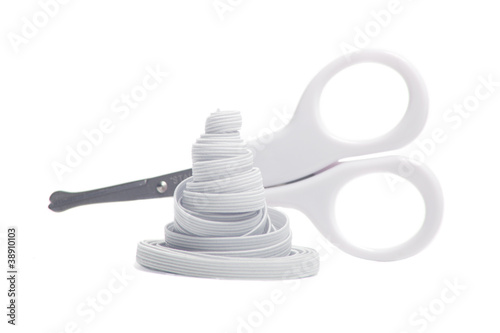 Scissors and elastic isolated on white background.