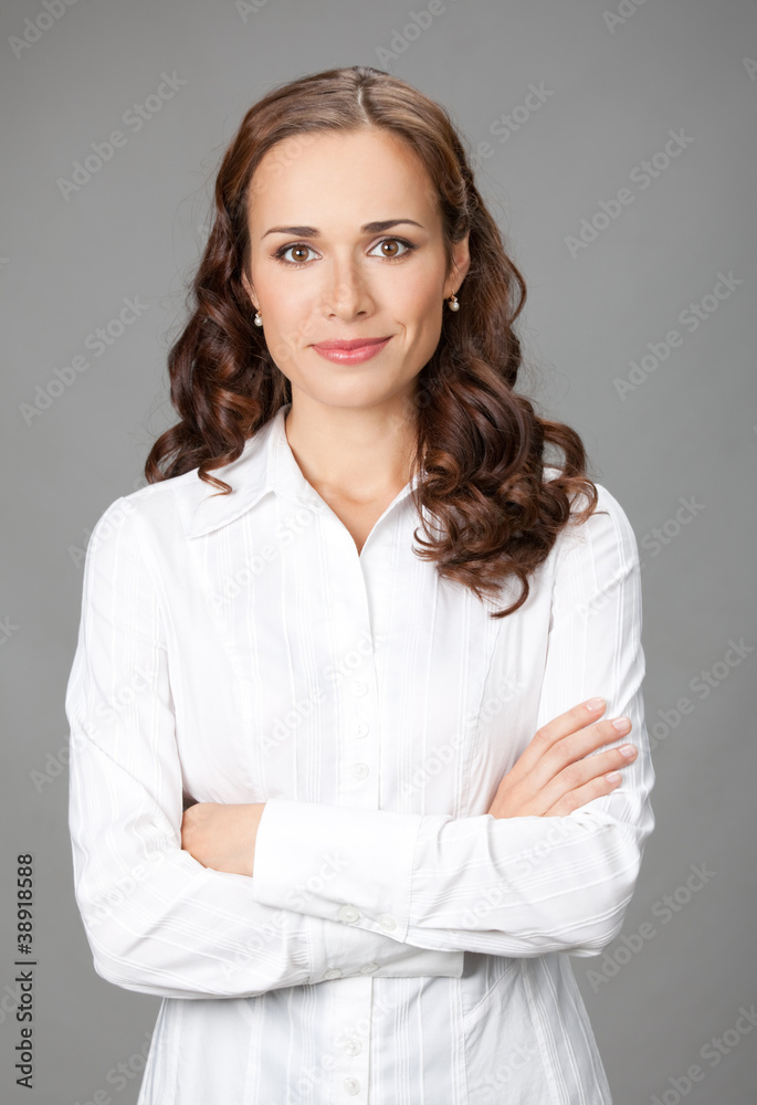 Smiling businesswoman, over gray Smiling businesswoman, over gray