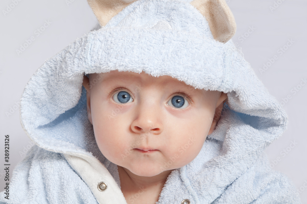 portrait of a cheerful child in blue bathrobe portrait of a cheerful child in blue bathrobe