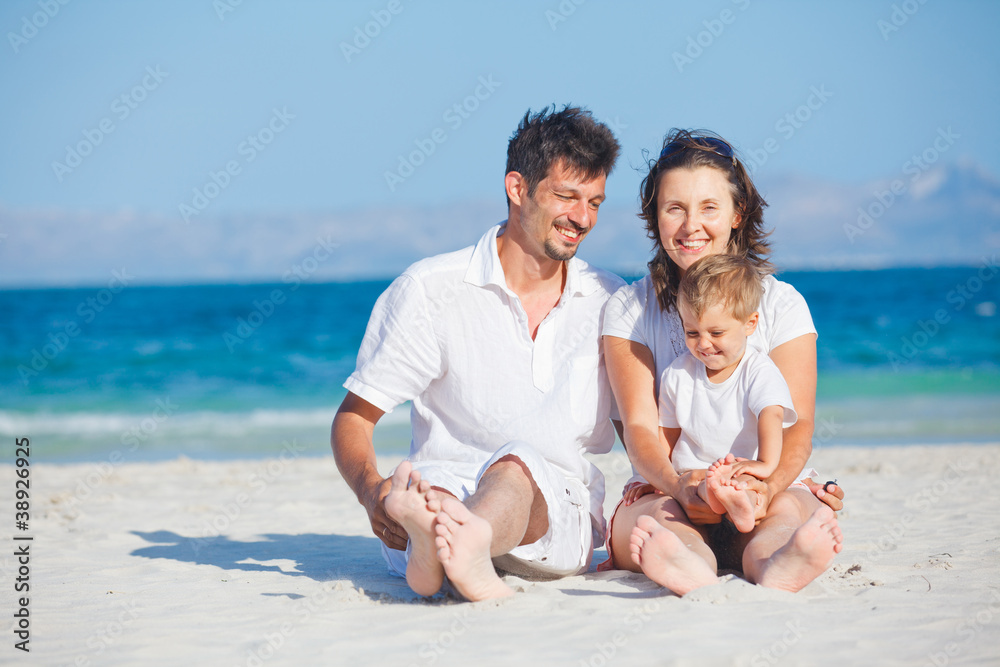 Family sitting on tropical beach Family sitting on tropical beach