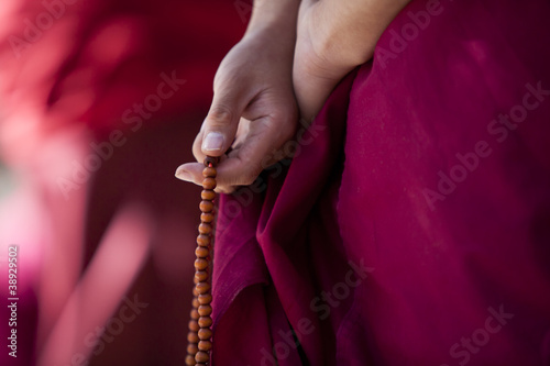 Fototapeta Prayer beads in monk's hand