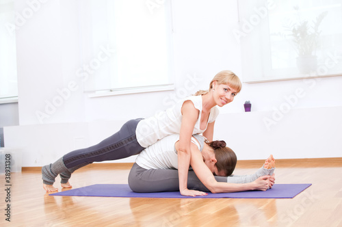 Women doing yoga exercise at gym