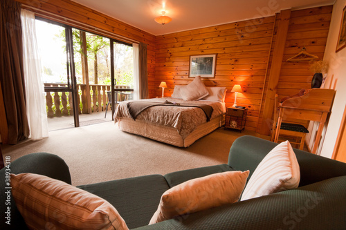 Fototapeta Interior of mountain wooden lodge bedroom