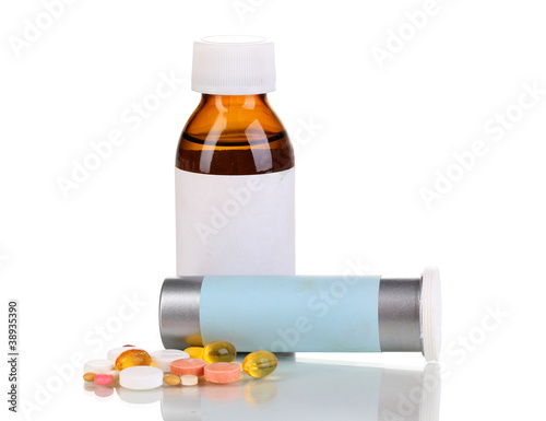 Medical bottles and tablets isolated on white