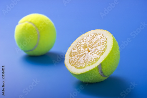 Lemon tennis balls on blue background