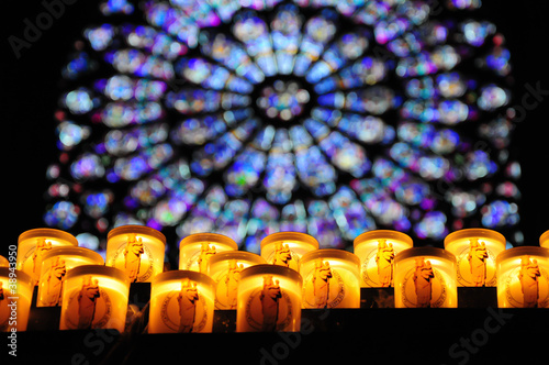 Prayer candles with rose window in Notre-Dame , Paris