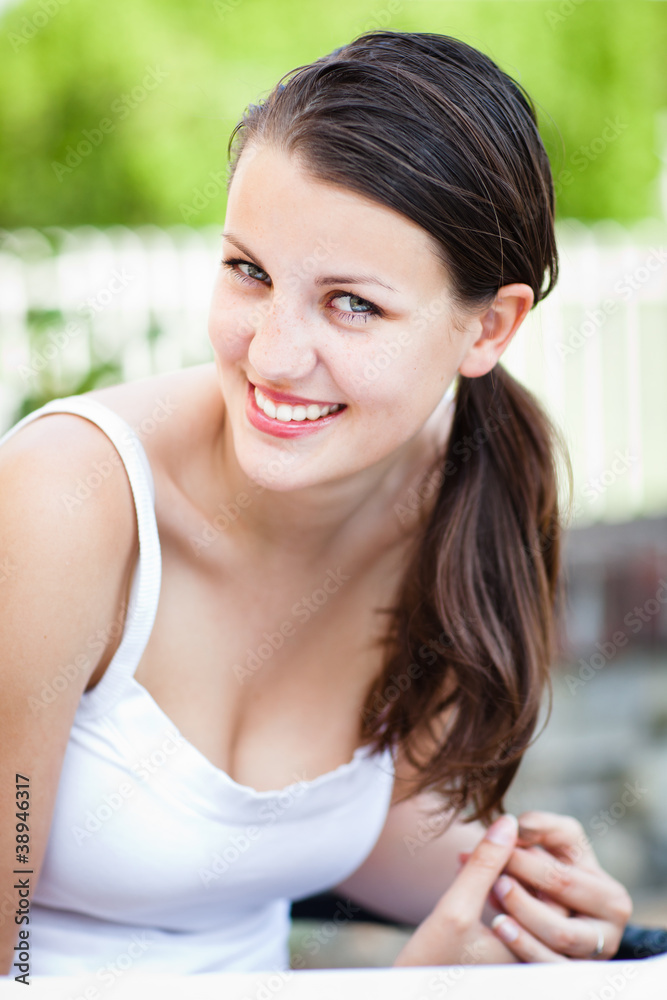 Close-up portrait of an attractive young woman outdoors.