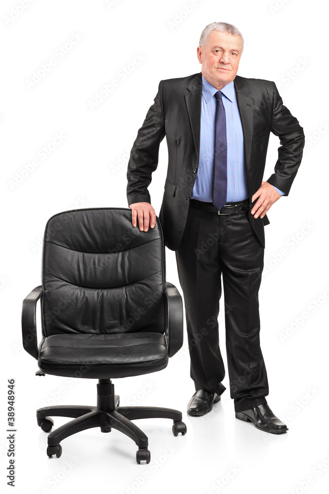 Full length portrait of a mature businessman standing next to a Full length portrait of a mature businessman standing next to a