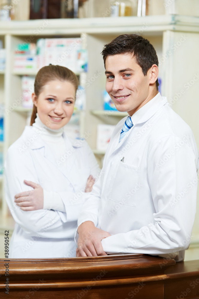 Two Pharmacy chemist workers in drugstore Two Pharmacy chemist workers in drugstore
