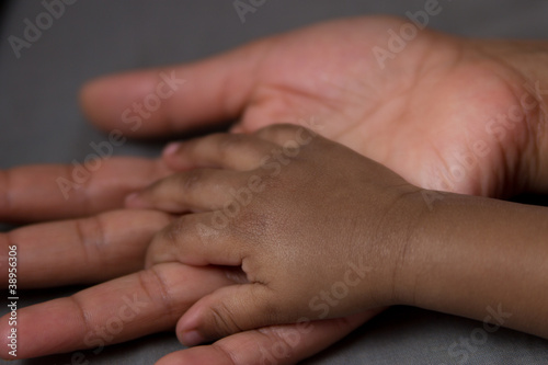 hand of a baby in his mother's hand