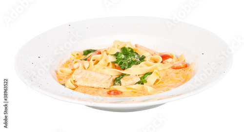 tasty pasta with cream, salmon, cheese and parsley close up