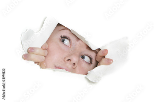 woman peeping through hole in paper