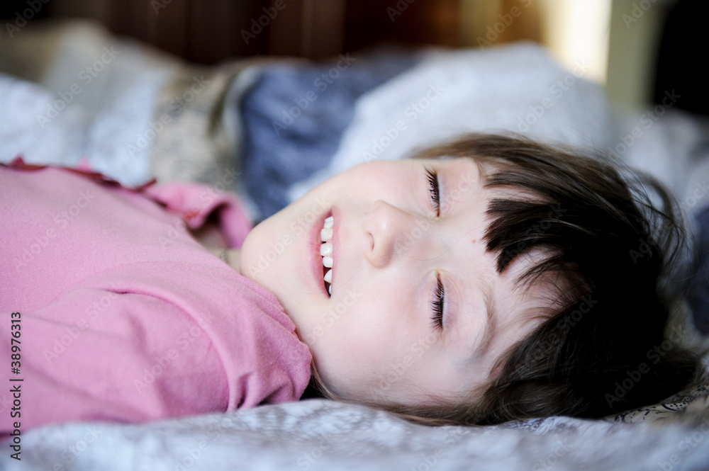 Adorable little girl resting in the bed