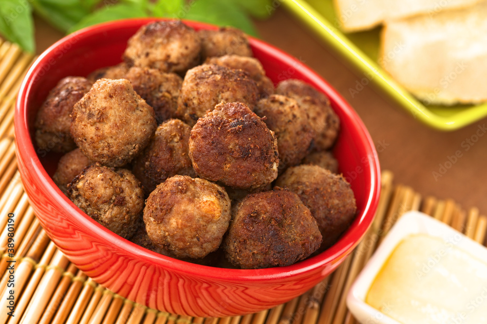 Meatball appetizers in a bowl with sauce and baguette Meatball appetizers in a bowl with sauce and baguette