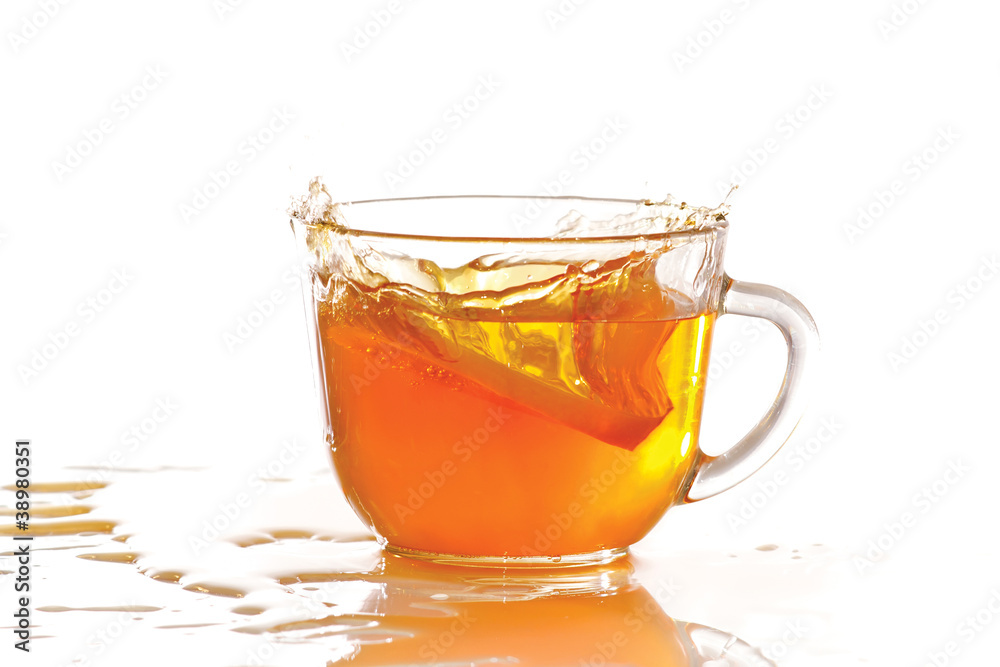 Cup of ice tea and lemon with splash on a white background Cup of ice tea and lemon with splash on a white background