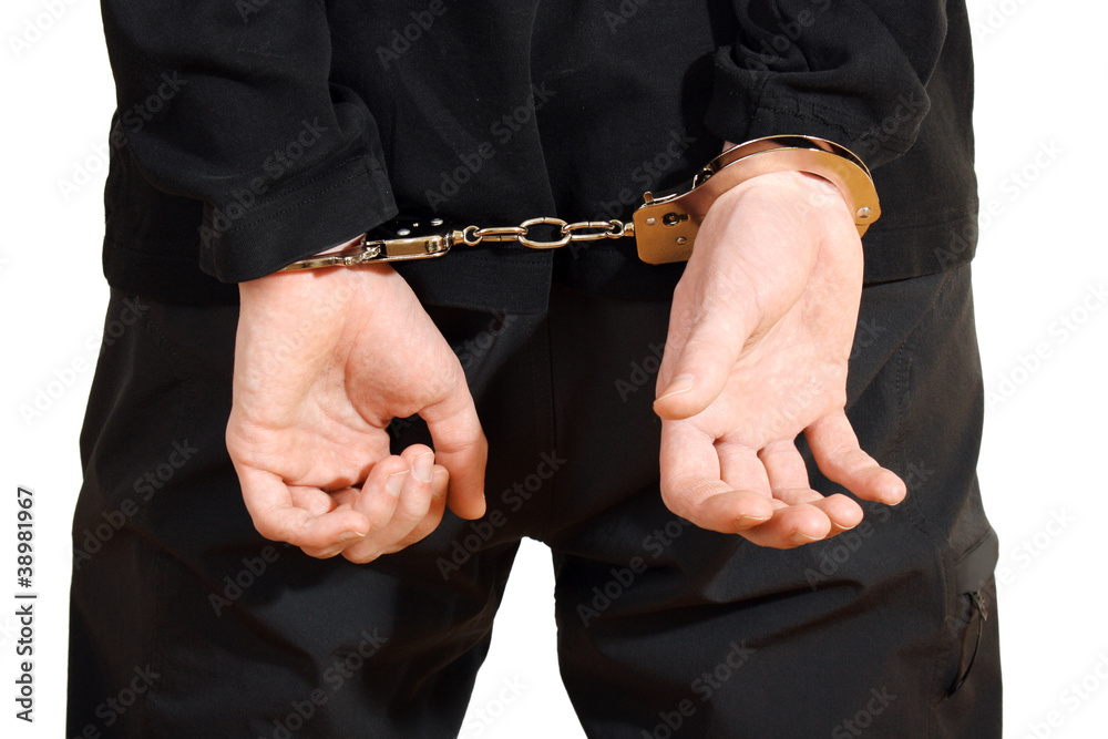 Bandit in black mask handcuffed isolated on white Bandit in black mask handcuffed isolated on white