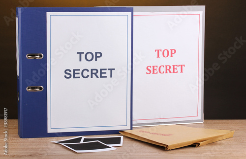 Envelopes and folders with top secret stamp and photo papers photo