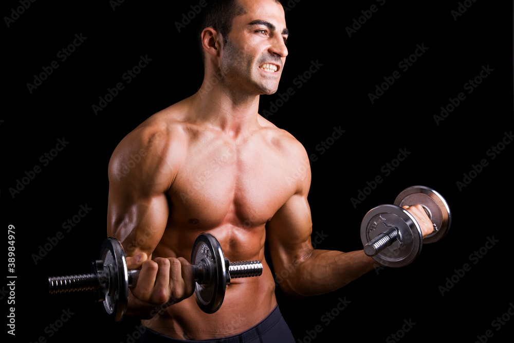 Young man lifting weights on black background Young man lifting weights on black background