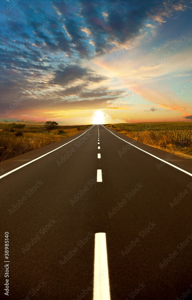 Naklejka premium Road ahead and the sunset