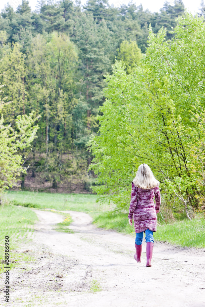 woman wearing rubber boots in spring nature woman wearing rubber boots in spring nature