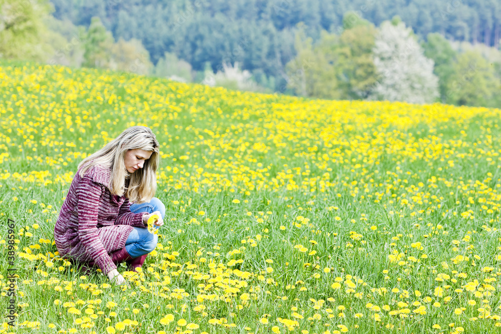 woman sitting on spring meadow woman sitting on spring meadow