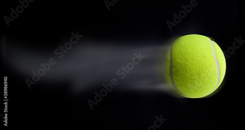 Tennis ball fast moving on black background © nexusseven