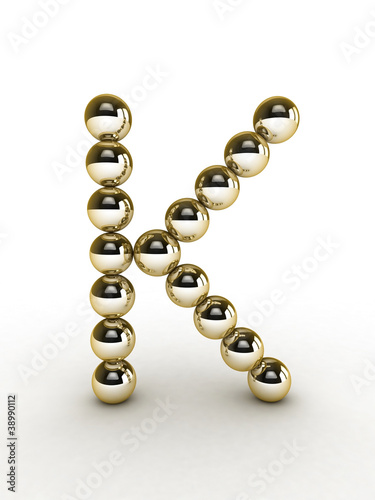 3d alphabet of gold beads.