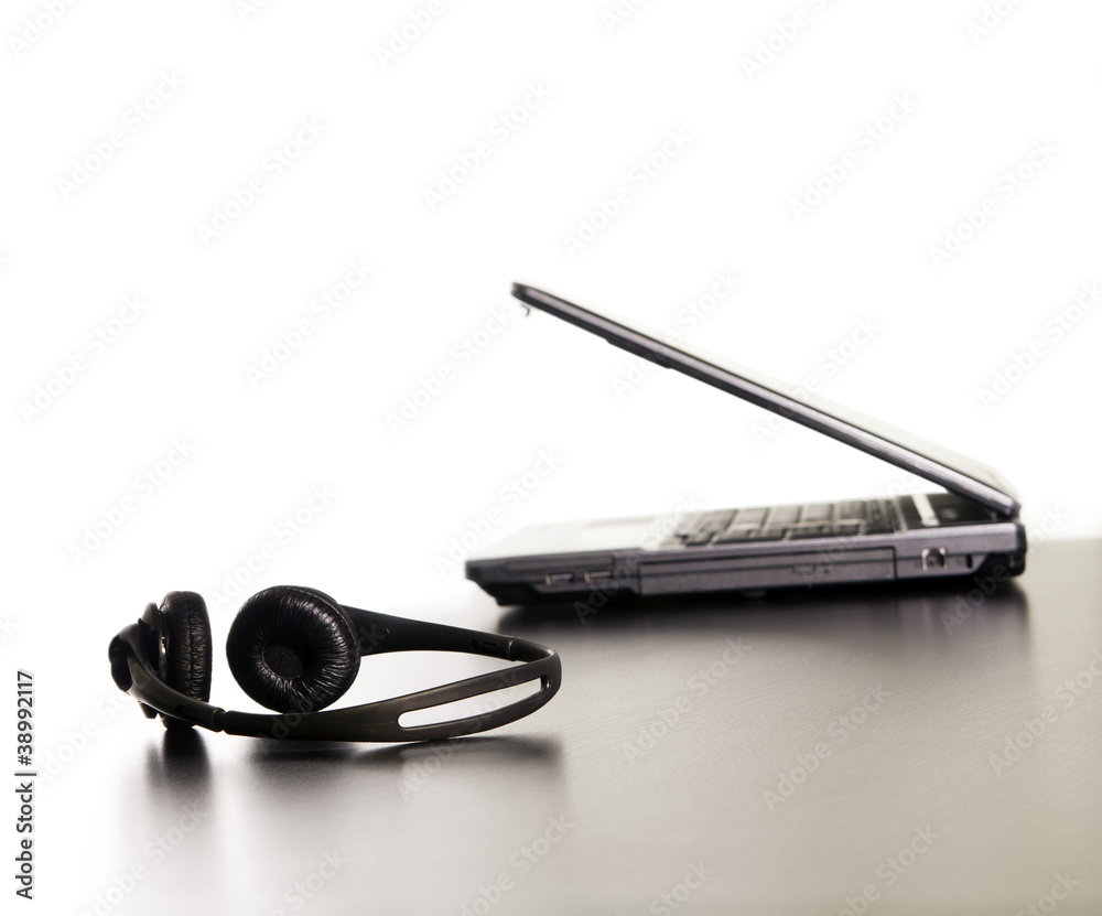 Computer and headset on the table, nothing else. Computer and headset on the table, nothing else.