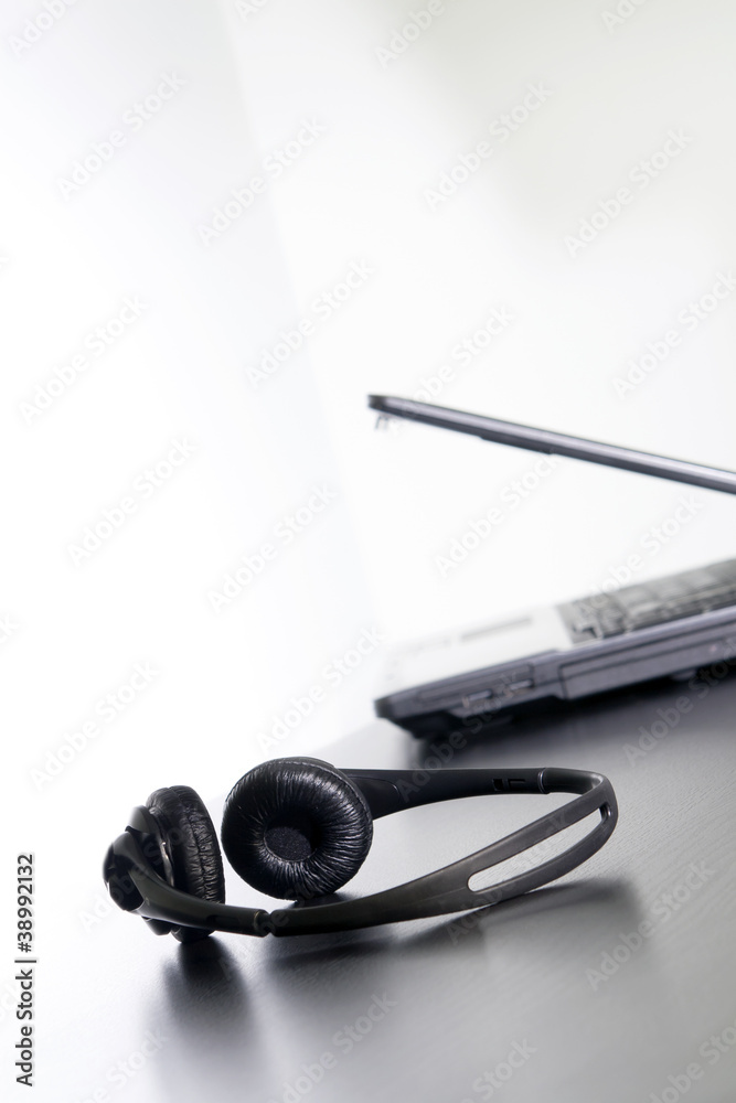 Computer and headset on the table, nothing else. Computer and headset on the table, nothing else.