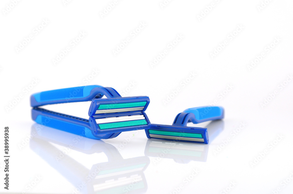 Three blue razors over white Three blue razors over white