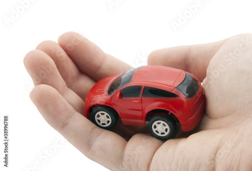 Hand holding a small red car. Clipping path included.