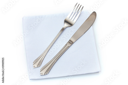 Fork and knife in a blue cloth isolated on white