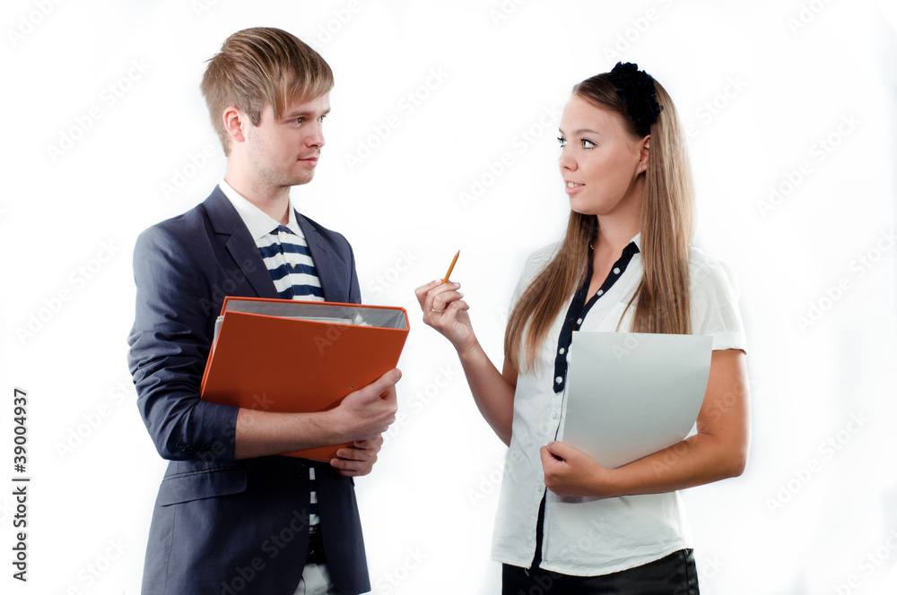Beautiful young woman explaining something to young man holding Beautiful young woman explaining something to young man holding