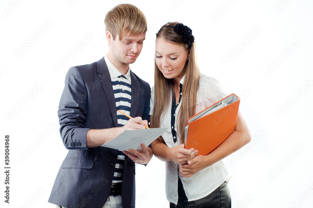 Young man explaining something to pretty young woman holding pap Young man explaining something to pretty young woman holding pap