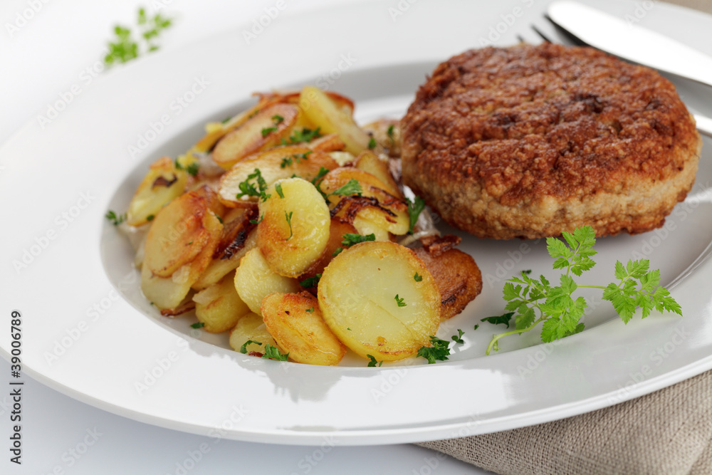 Frikadelle mit Bratkartoffeln Stock Photo | Adobe Stock