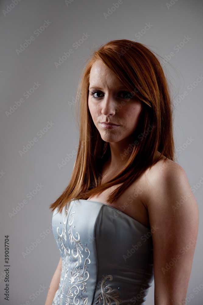 Redhead woman looking seriously at the camera Redhead woman looking seriously at the camera