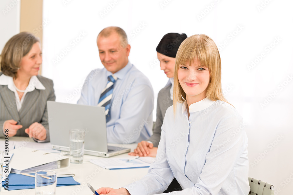 Businesswoman at team meeting with colleagues Businesswoman at team meeting with colleagues