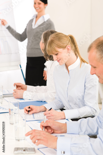 Giving presentation young woman during meeting