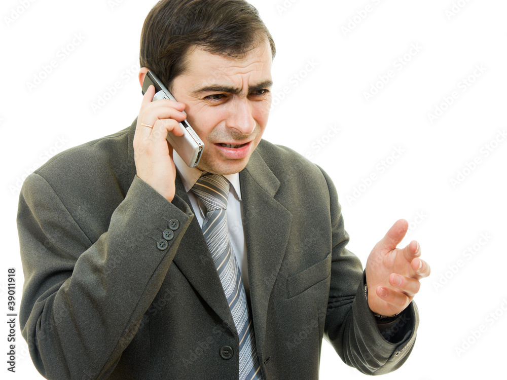 Businessman in distress speaks by phone on a white background Businessman in distress speaks by phone on a white background