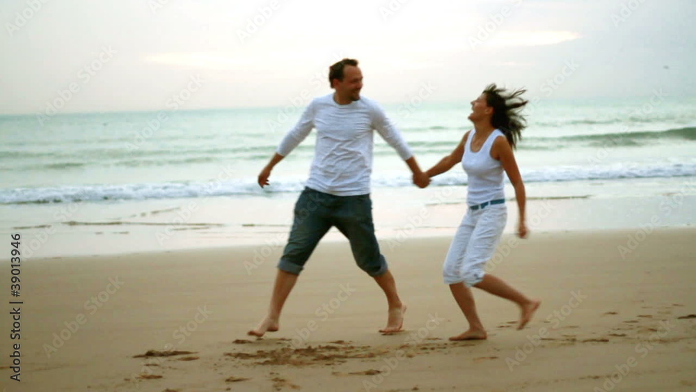 Happy coupple running and on the beach, slow motion Happy coupple running and on the beach, slow motion