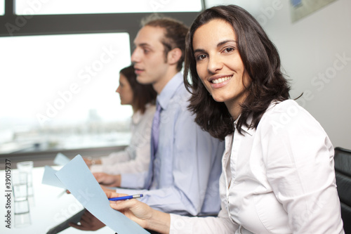 Latin businesswoman smiling in office