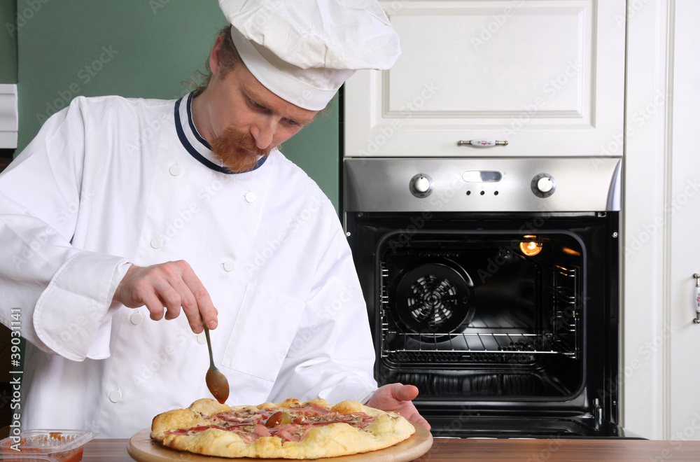 Young chef prepared italian pizza in kitchen Young chef prepared italian pizza in kitchen