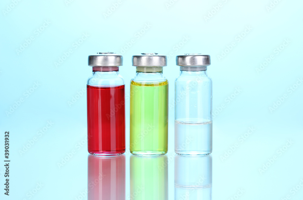 Medical ampoules on blue background Medical ampoules on blue background