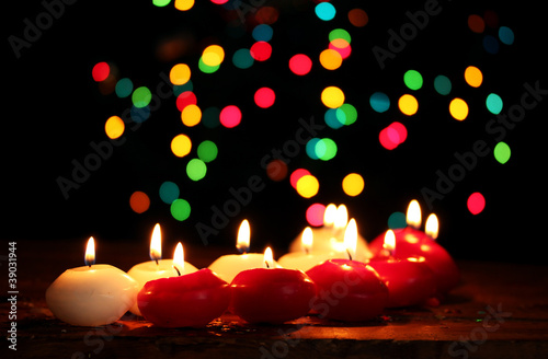 Beautiful candles on wooden table on bright background