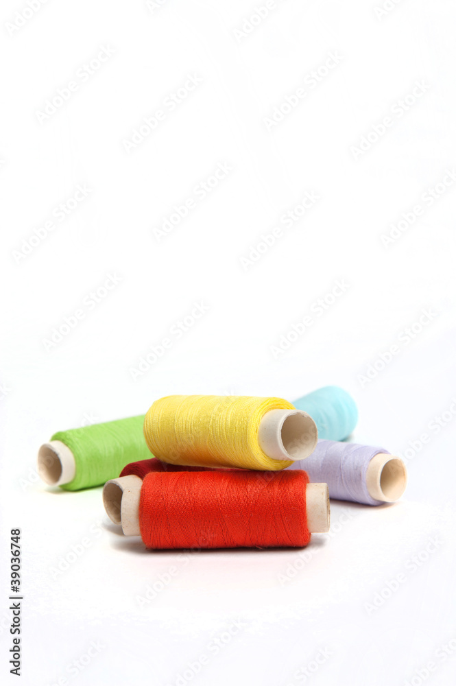 Color threads with needle and thimble Color threads with needle and thimble