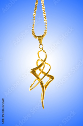 Golden jewellery against gradient background